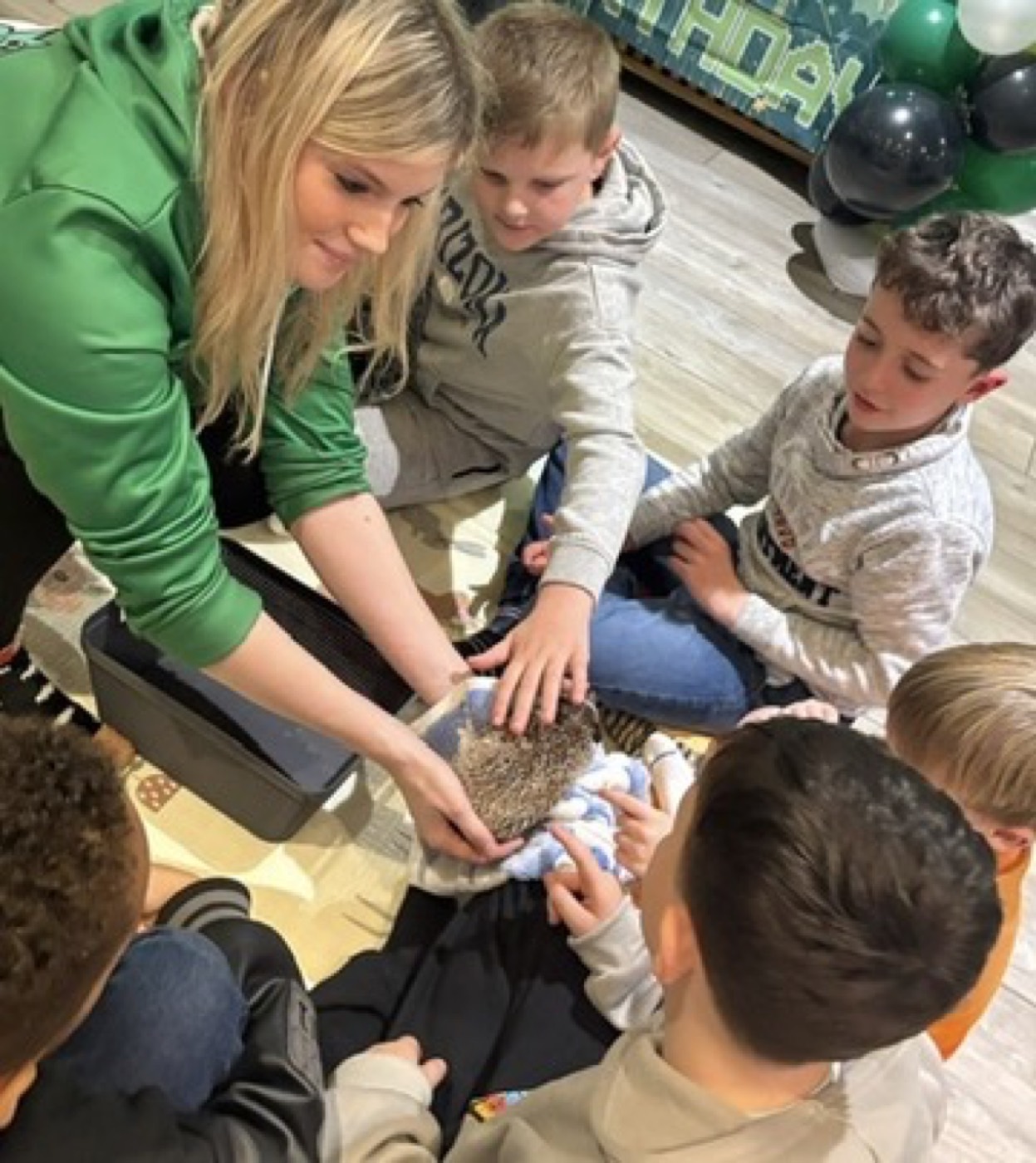 Ciera O'Rourke sharing a hedgehog with a group of children